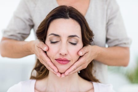 Woman's face with eyes closed during Reiki Massage by Nirvana Wellness Massage